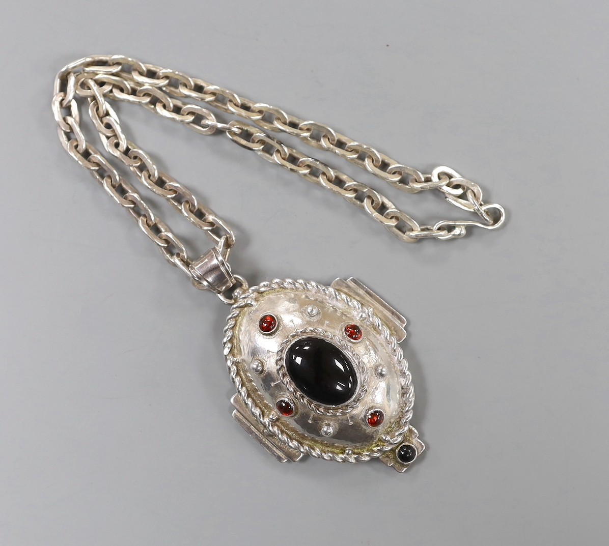 A modern silver and cabochon gem set pendant, on an oval link chain, by Michael Allen Bolton, London, 1992, pendant overall 93mm, chain, 46cm, gross weight 176 grams.